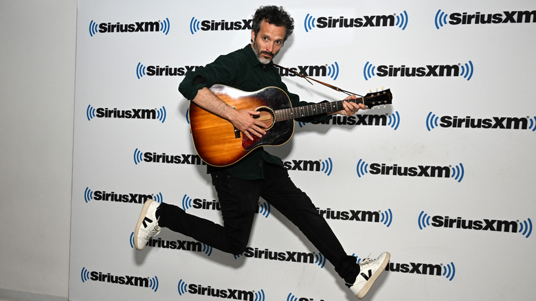 Bret McKenzie jumping with guitar
