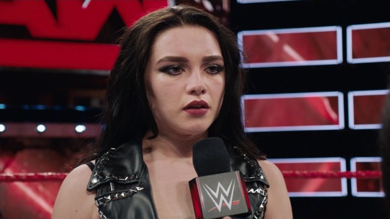 Paige holding a microphone