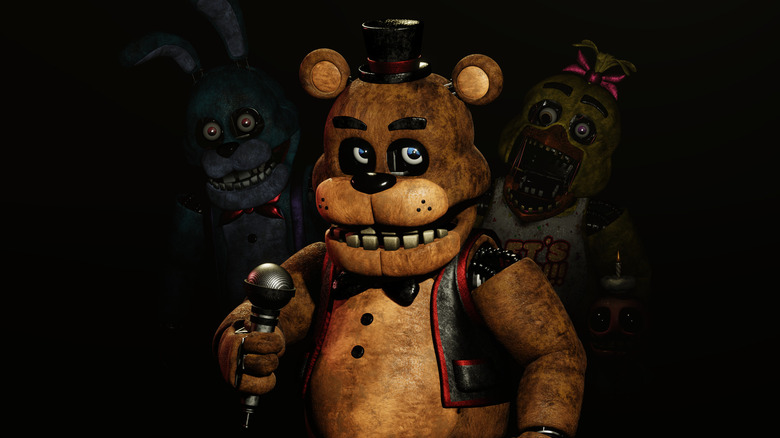 Freddy holds a mic and grins