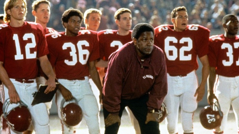 Denzel Washington stands in front of Titans