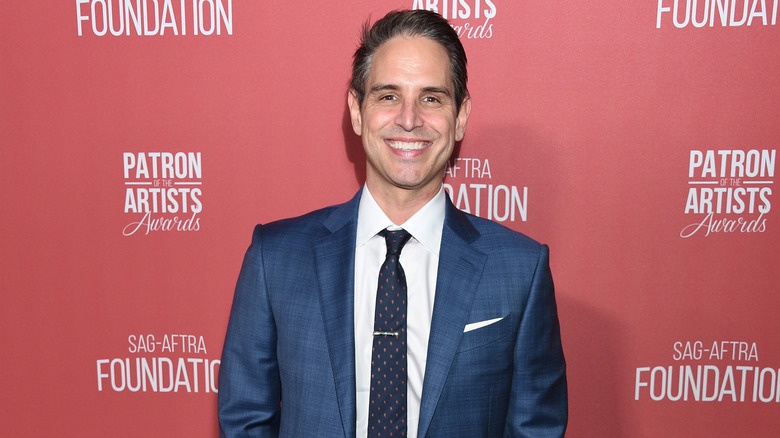 Producer Greg Berlanti smiles