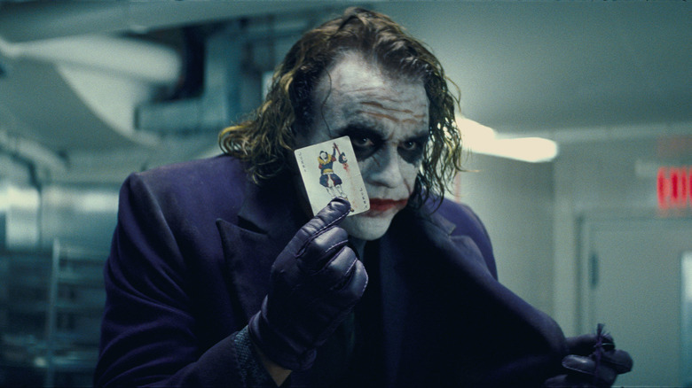 Joker holds up a card