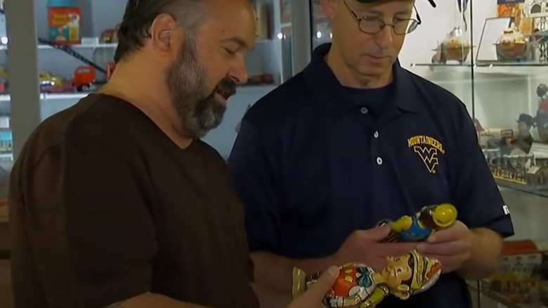 Frank Fritz examining a figurine