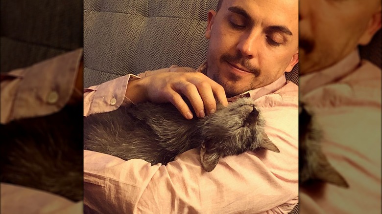 Frankie Muniz petting his cat