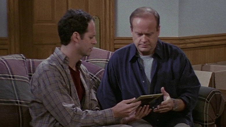 Frasier looks at a photo with Phillip 