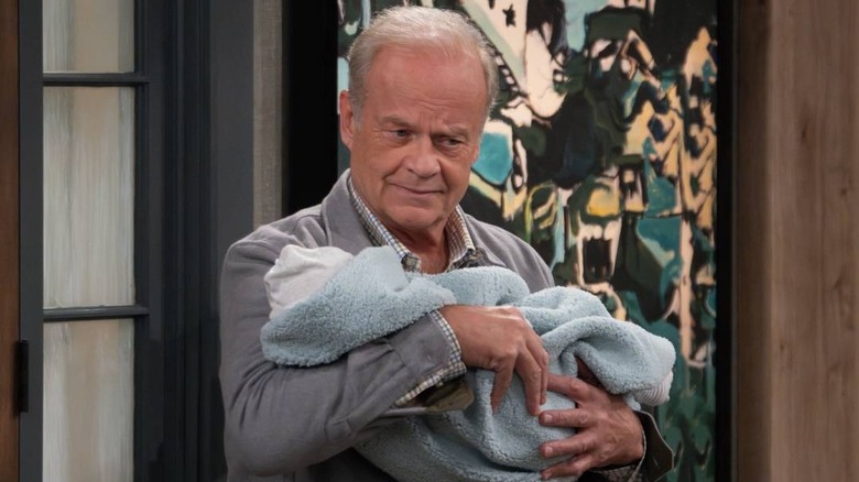 Frasier Crane holding a baby