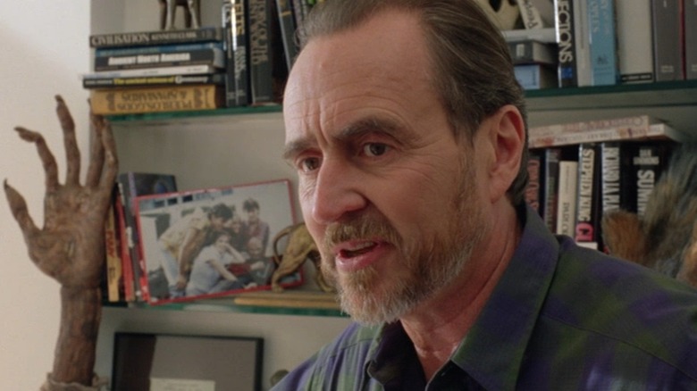 Wes Craven, bookshelf, creepy hand in background