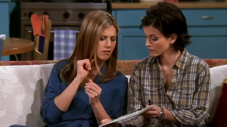 Monica and Rachel looking at notebook