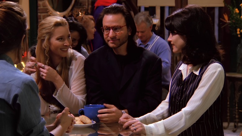 Phoebe and Monica looking at Roger