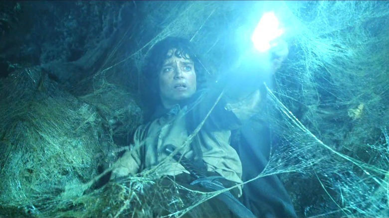 Frodo holding a light