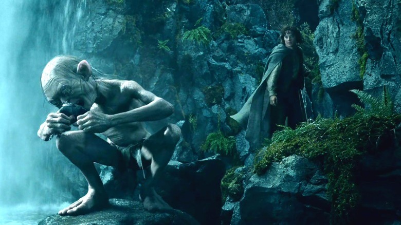 Frodo behind Gollum at waterfall