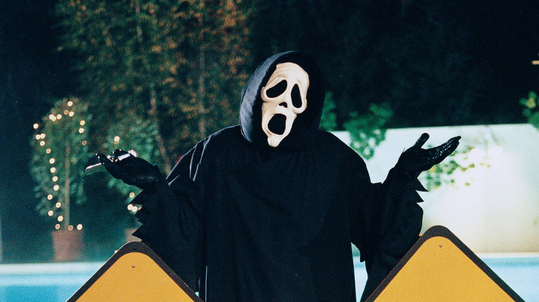 Ghostface shrugs while holding a knife in "Scary Movie" (2000)(