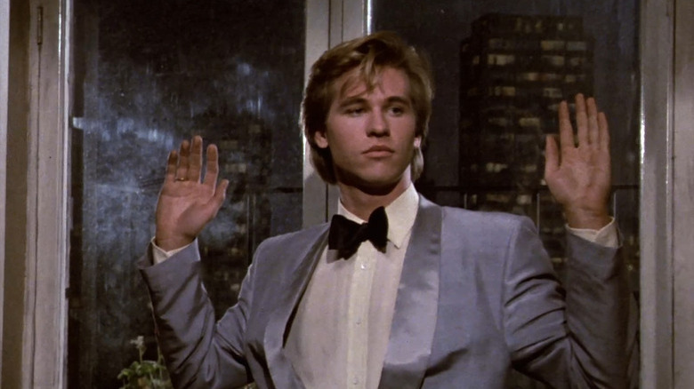 Nick Rivers holds his hands in the air in "Top Secret!" (1984)