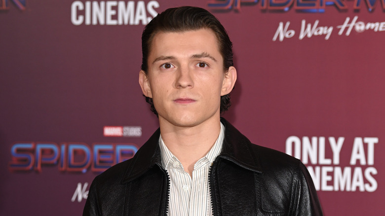 Tom Holland posing at photocall