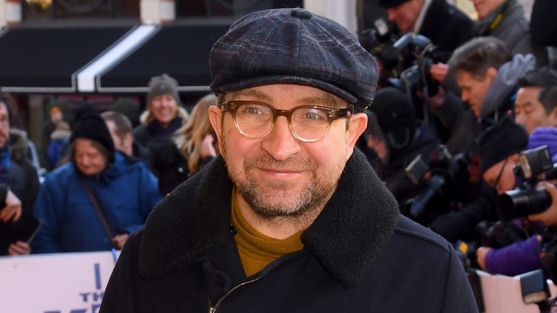 Eddie Marsan wearing a hat and glasses