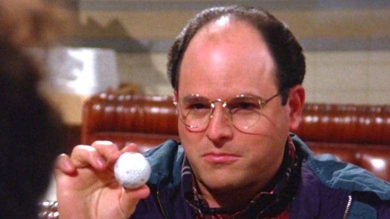 george holding golf ball