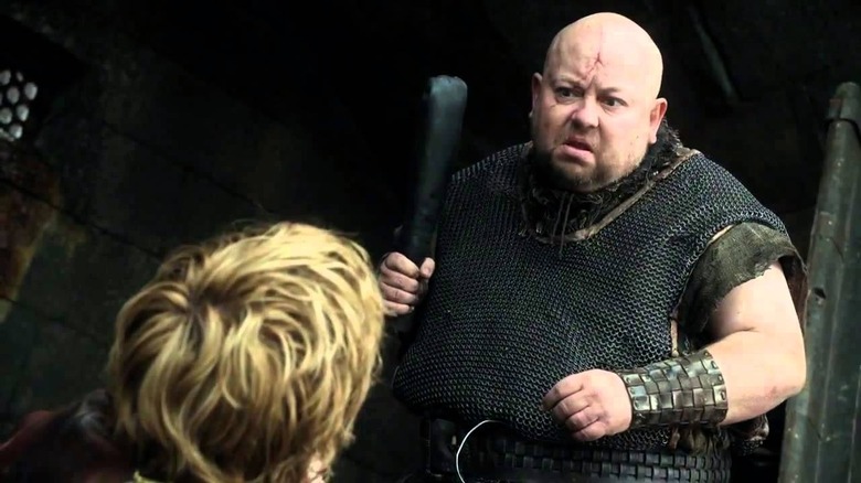 Mord holding club over Tyrion