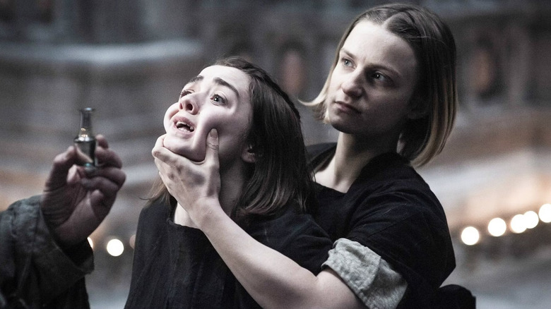 Waif holding Arya's face