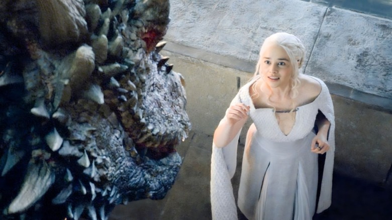 Daenerys Targaryen looking up at a dragon