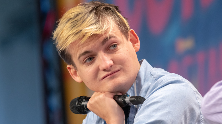 Jack Gleeson sitting on stage for Q&A