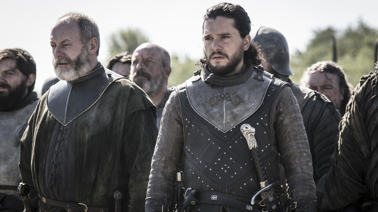 Jon Snow and Davos standing with men