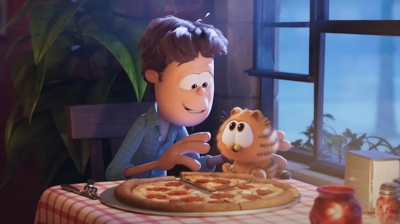 Jon and baby Garfield share a pizza