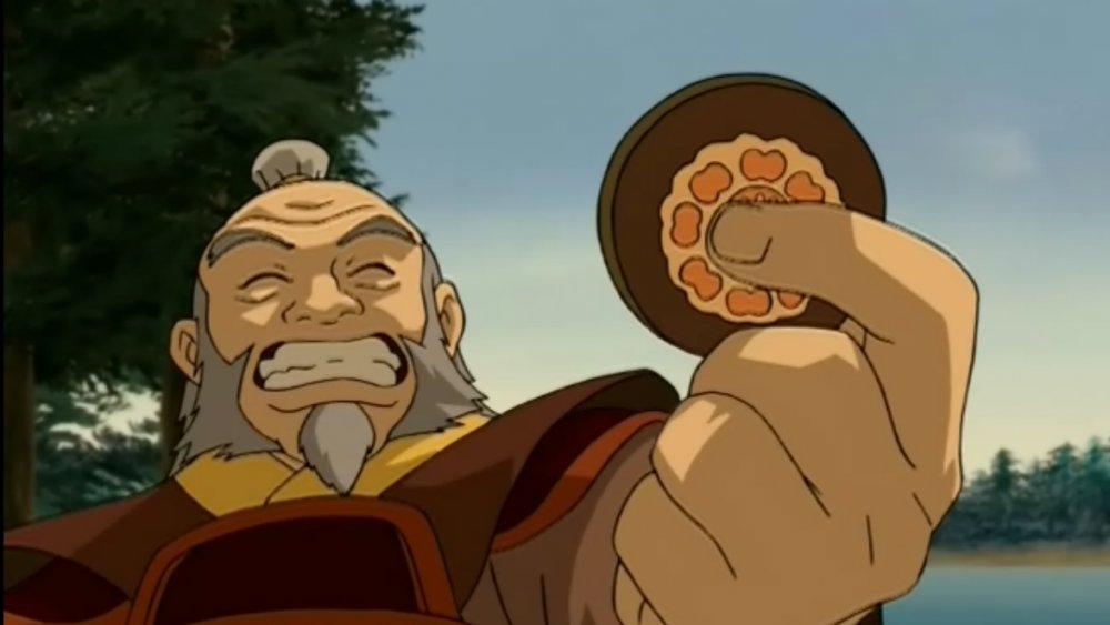 Iroh holding a Pai Sho Lotus tile in Avatar: The Last Airbender