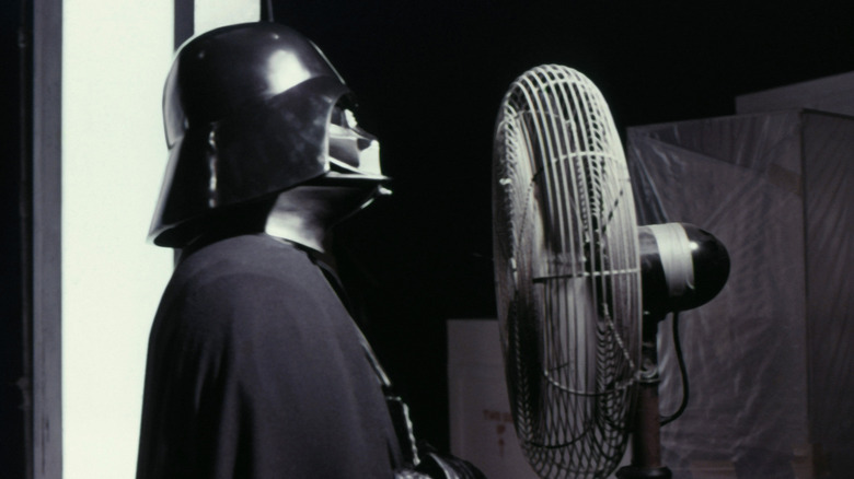 Darth Vader standing near fan