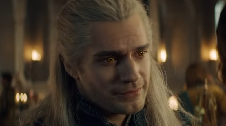 Geralt looking at Jaskier with fondness