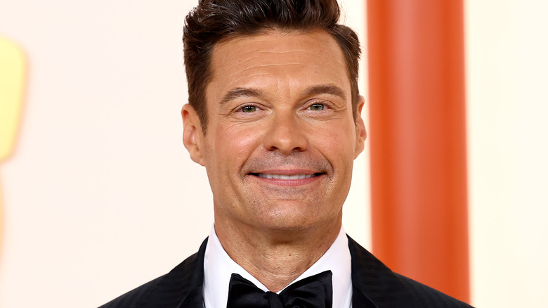 Ryan Seacrest smiling at event