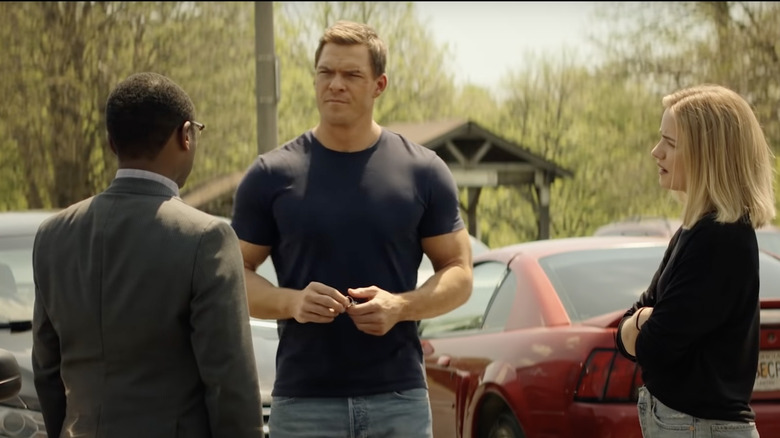 Reacher characters stand near cars