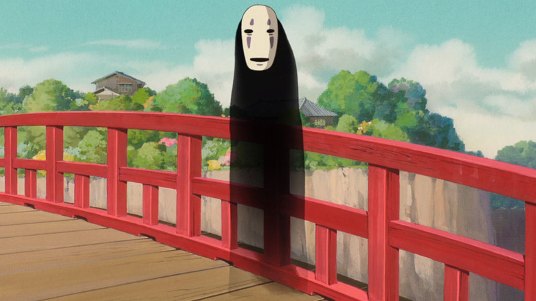 No-Face standing on a bridge