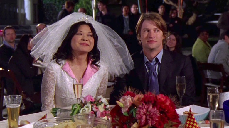 Lane and Zack sit at wedding table 