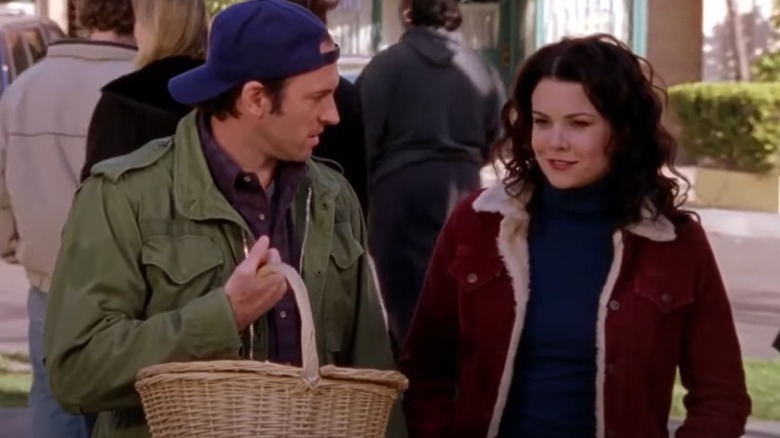 Luke holding basket walking with Lorelai