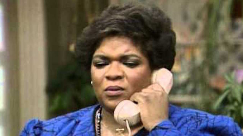 Nell Carter holds a telephone receiver to her ear