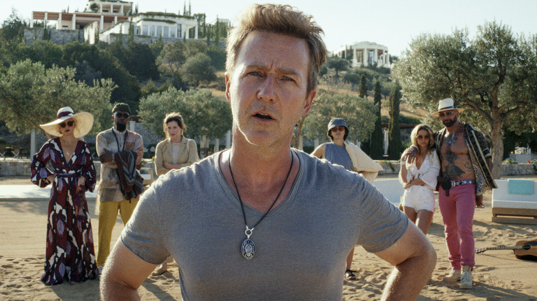 Edward Norton looks confused on a beach