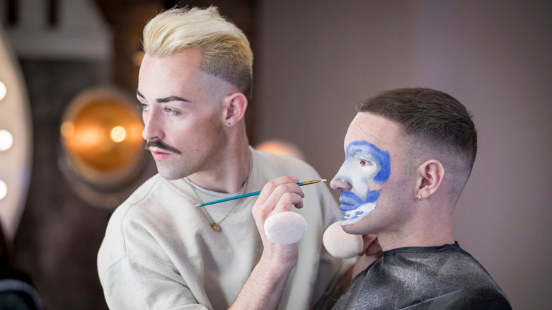 James applying makeup