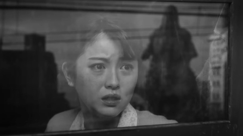 Frightened woman watching Godzilla