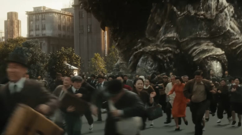 Crowd running from Godzilla's foot