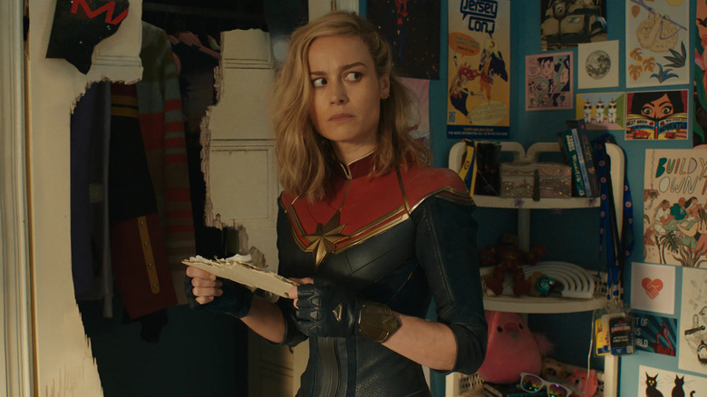 Captain Marvel holding broken door