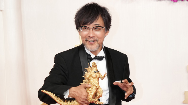 Takashi Yamazaki posing with Godzilla