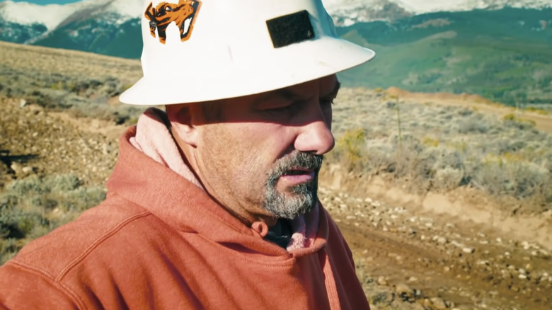 Dave Turin looking down at the dirt