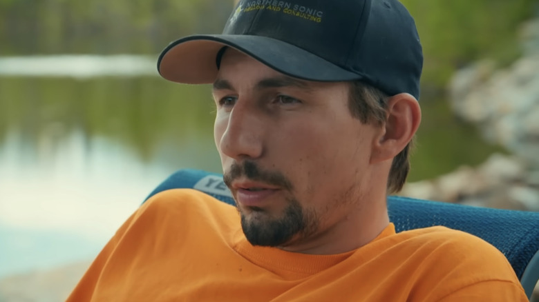 Parker Schnabel sitting beside a lake