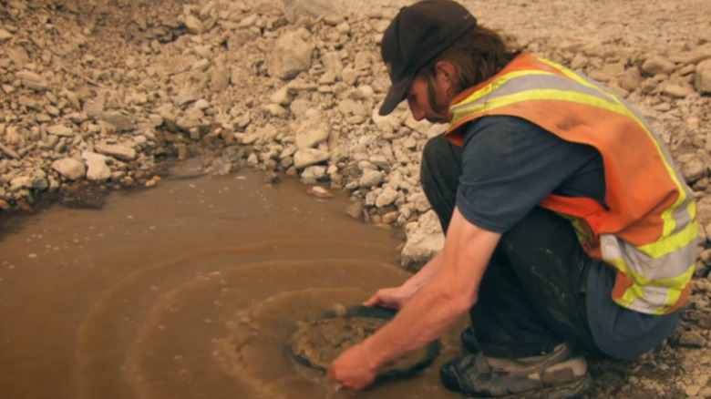 Parker using a pan for gold