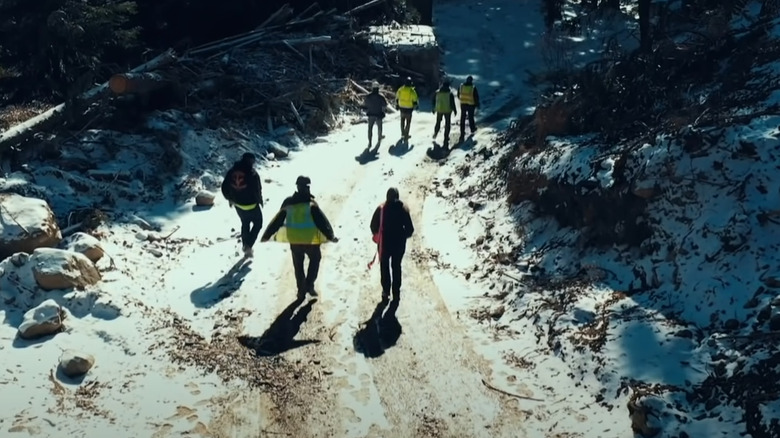 Fred Lewis and his crew walking away from a site 