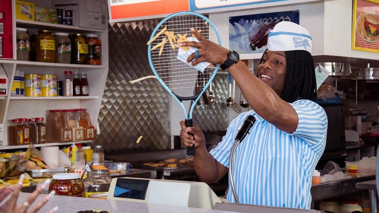 Ed serves fries with racket