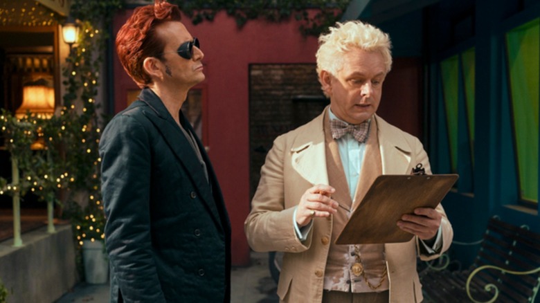 Crowley looking at Aziraphale, who's looking at clipboard