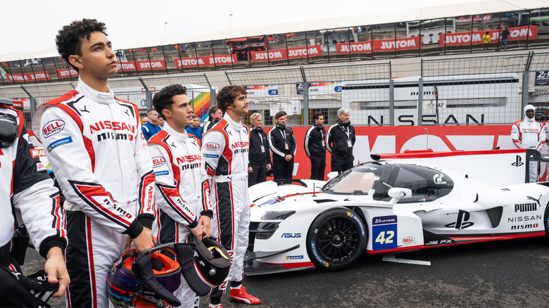 Jann standing by his car