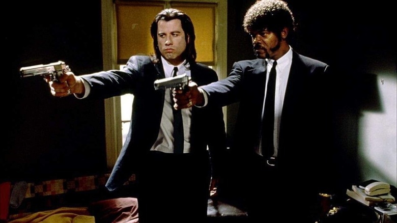 John Travolta and Samuel L. Jackson holding people at gunpoint