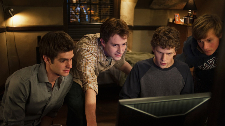 Jesse Eisenberg showing off a new website to his friends